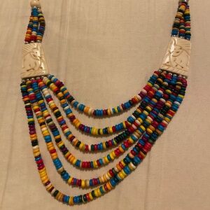 Multi-strand multi-color ethnic style beaded bib necklace w/carved elephants.